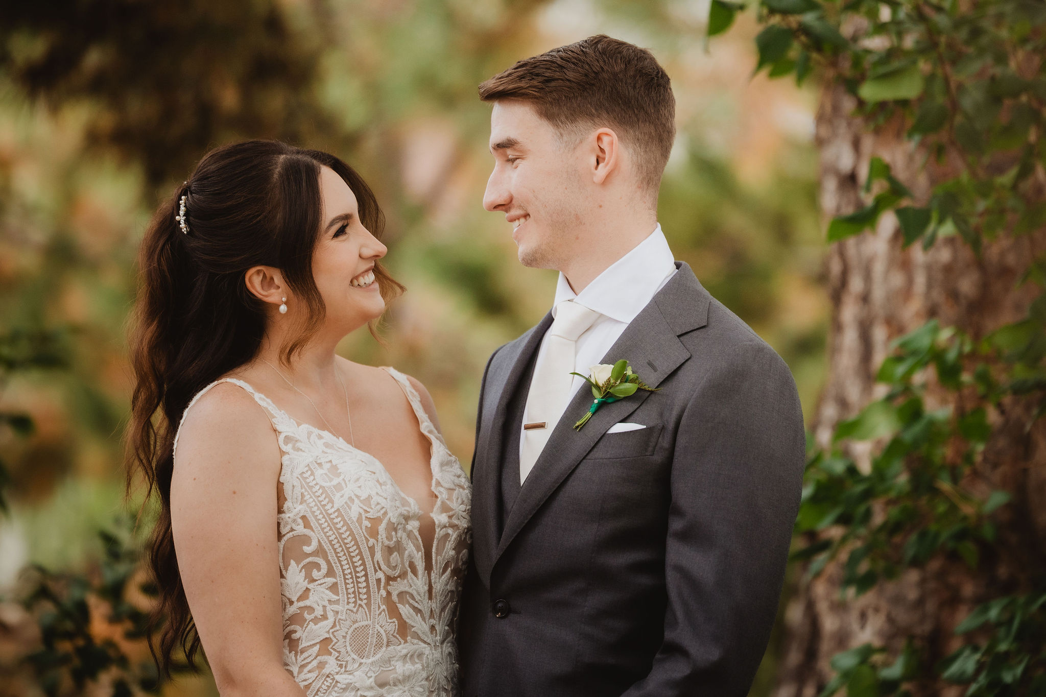 Brittney and Trevor smiling in the trees