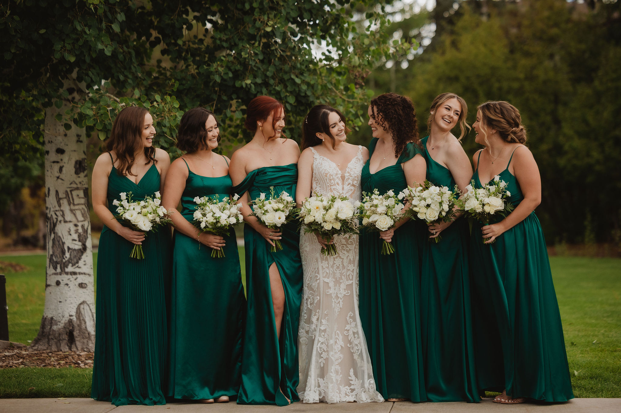 Brittney with bridesmaids in emerald green dresses