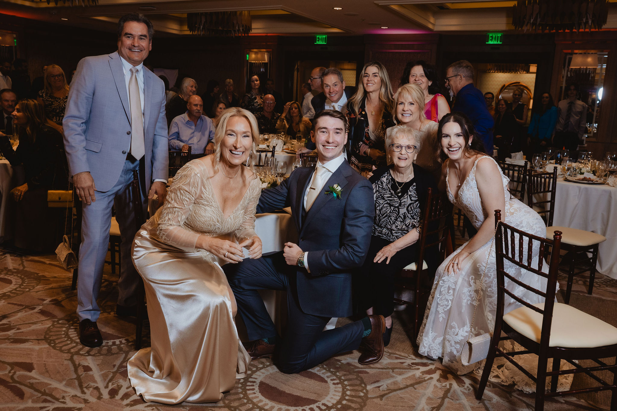 Brittney and Trevor posing quickly with a reception table