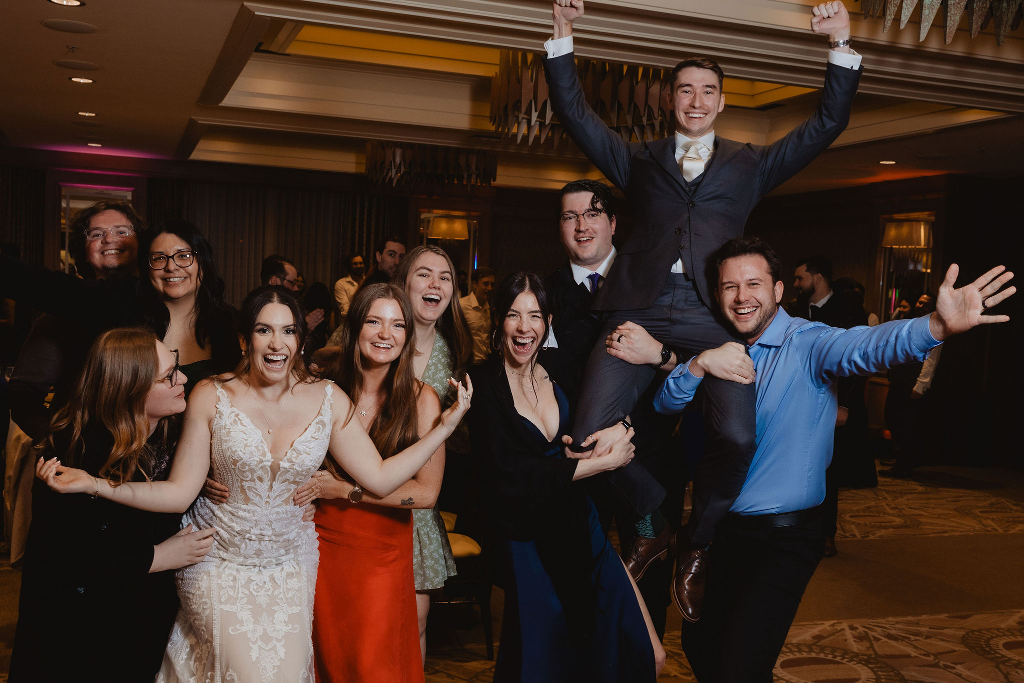 Brittney and Trevor with a large group of wedding guests