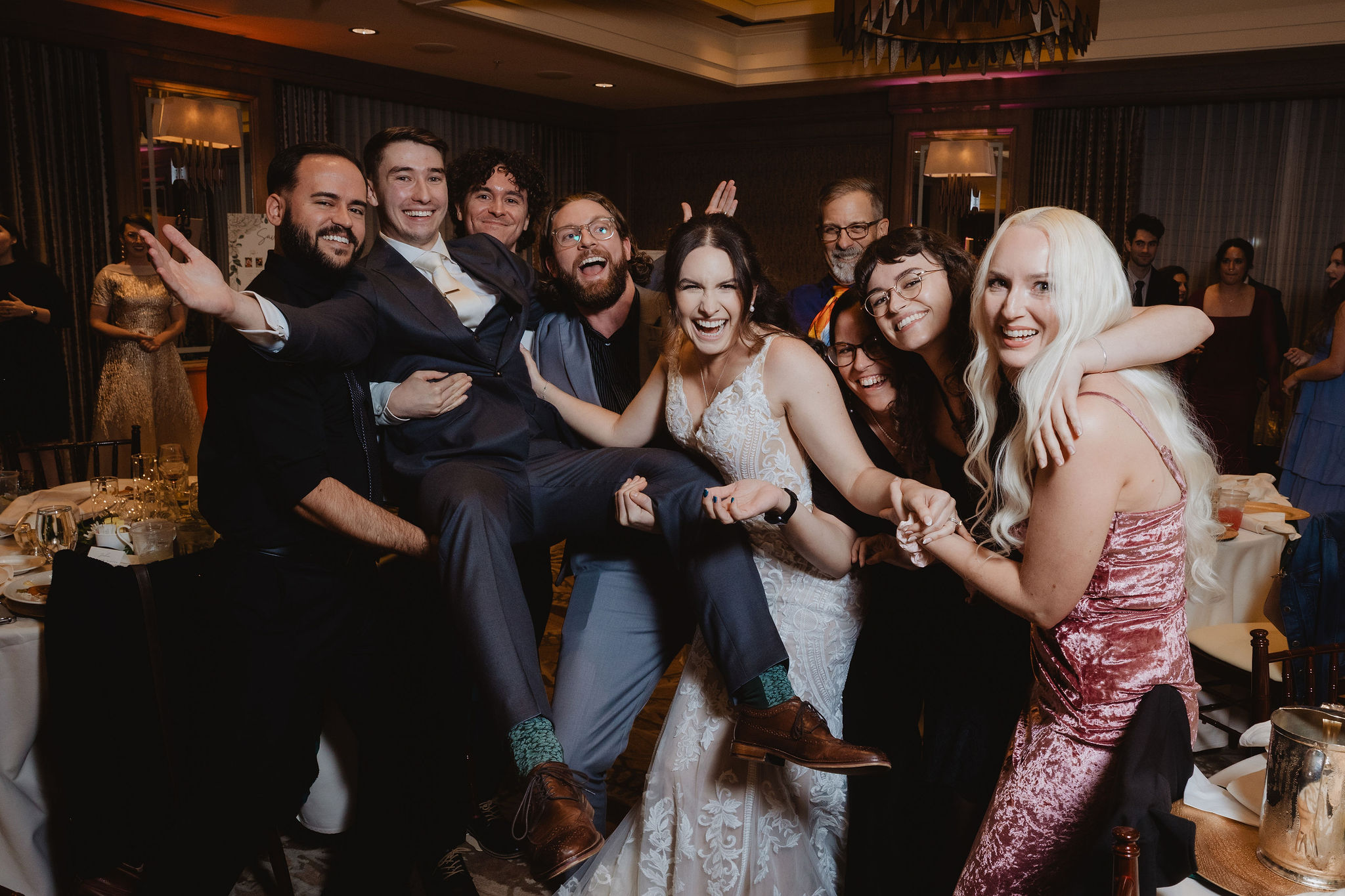 Brittney and Trevor surrounded by reception guests
