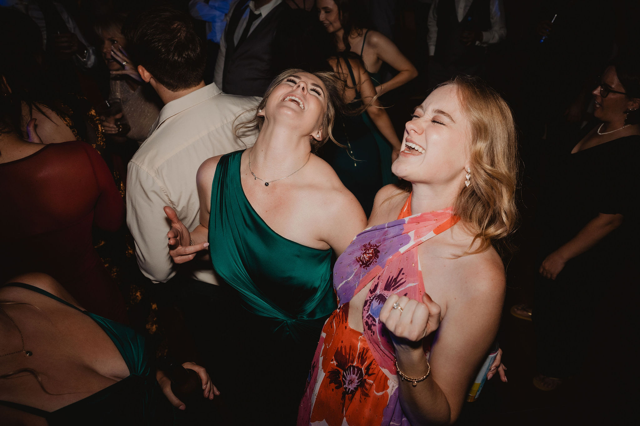 Guests laughing and dancing at the reception